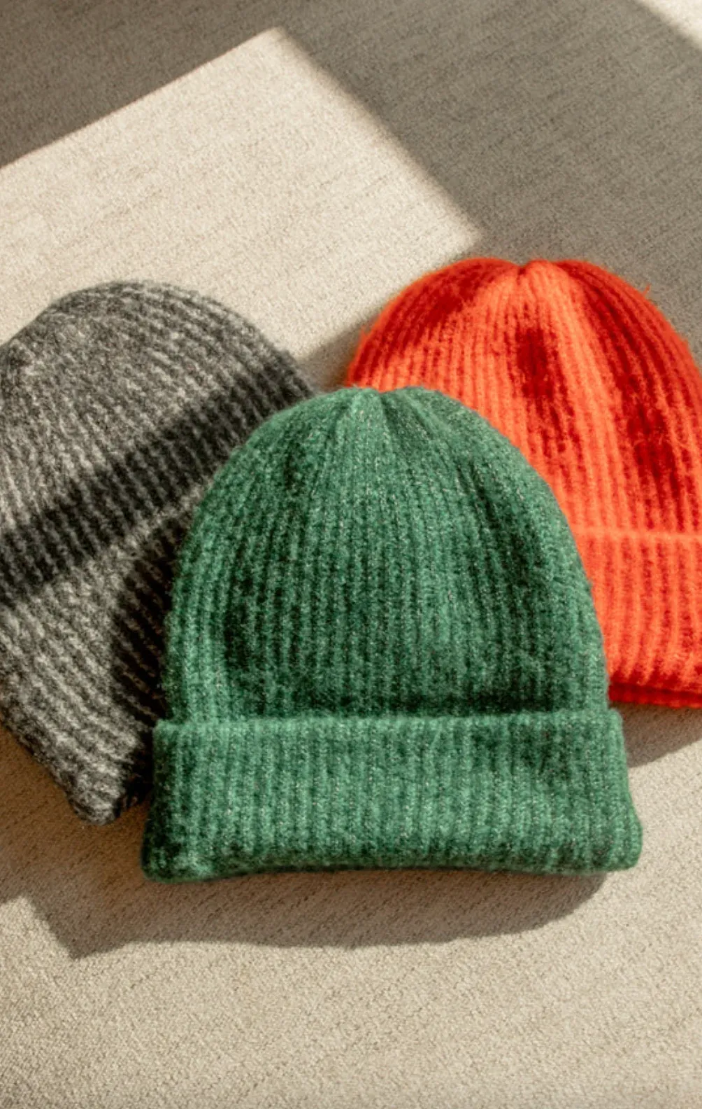 Ribbed beanies in green, orange, and gray
